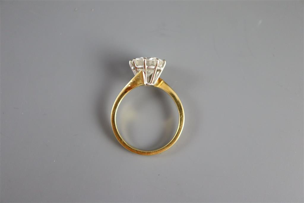 A modern 18ct gold and solitaire brilliant cut diamond ring,